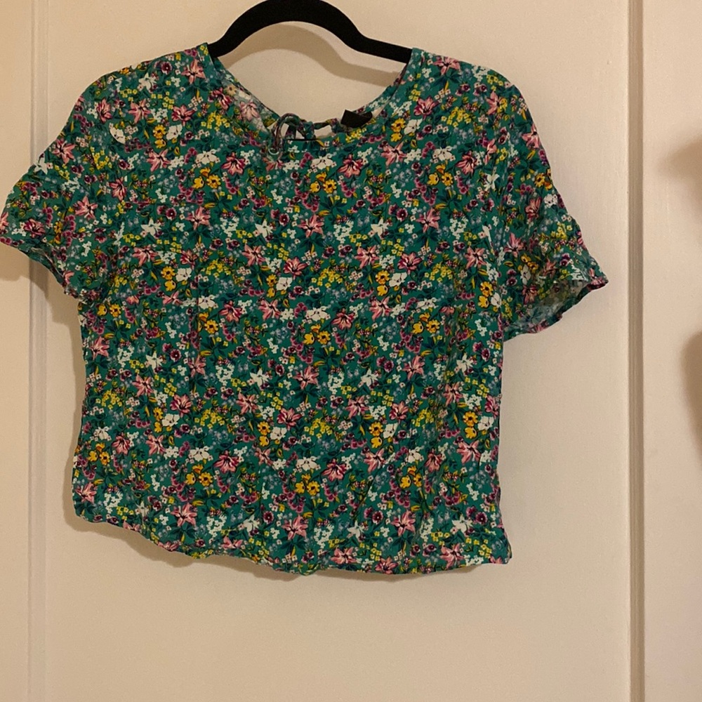 green cropped t shirt with pink and yellow floral detail. Back tie